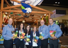 A proud CMI Orchards team, showing differnt pouch bags of organic branded and non-branded apples.